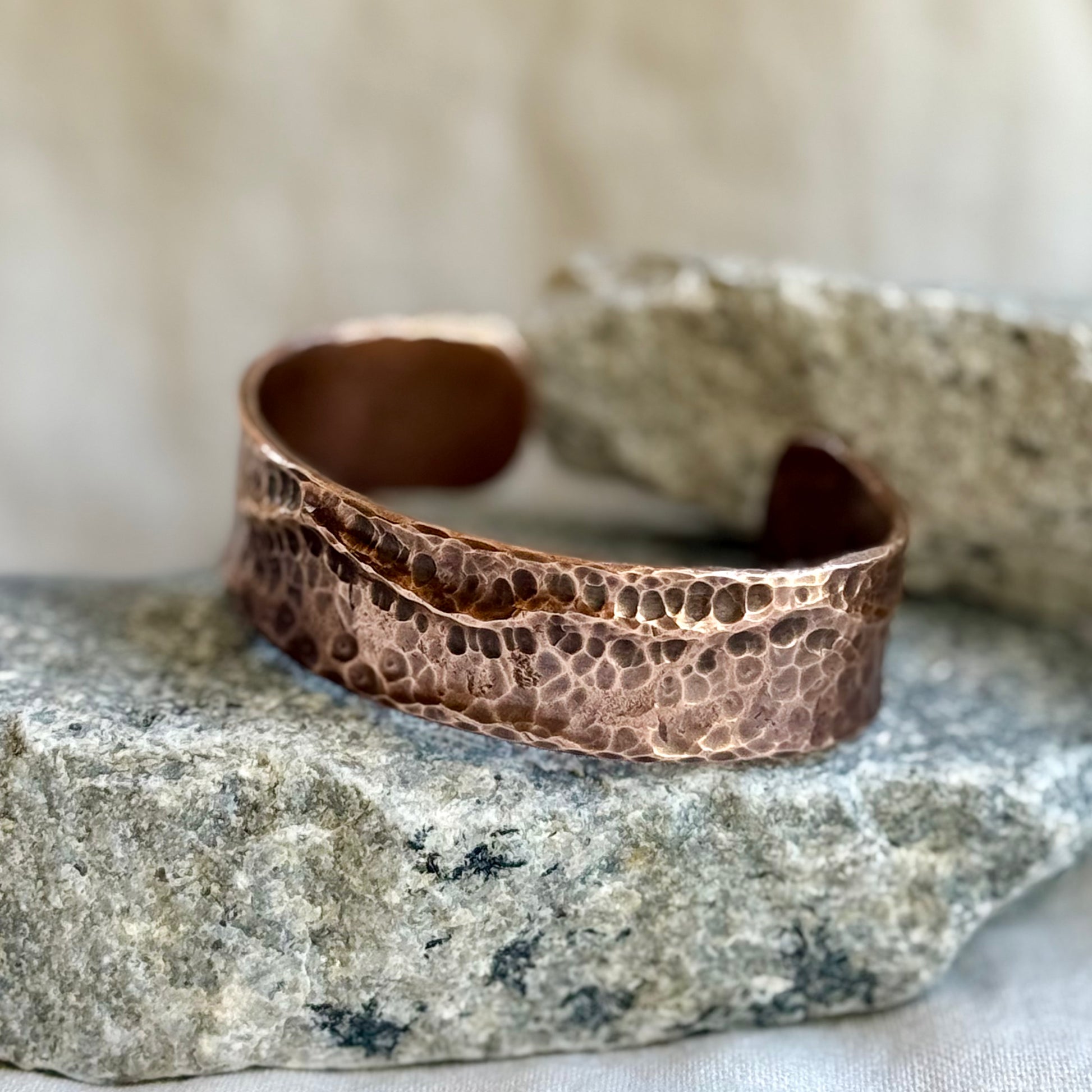 Copper bracelet on a textured stone surface