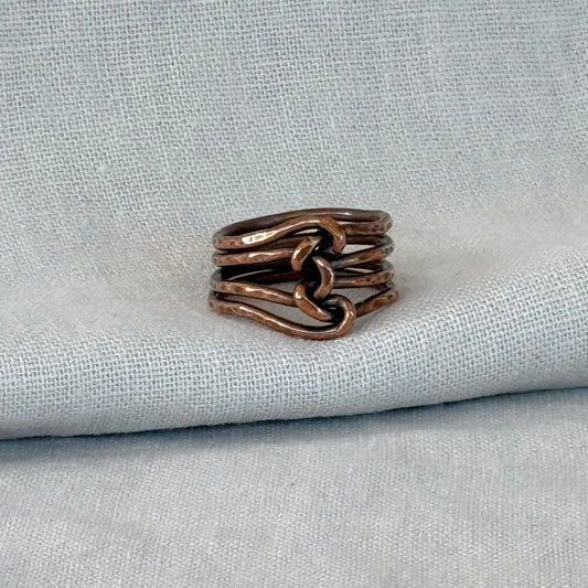 Copper wire ring on linen fabric