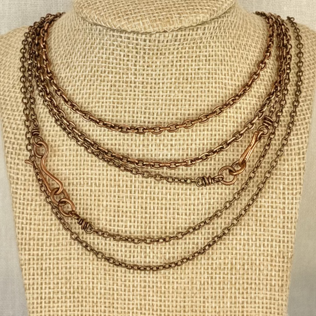 set of copper chains on a woven fabric necklace display bust with linen background