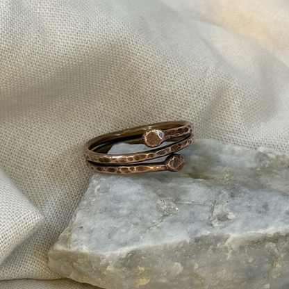 Copper ring on a stone surface with linen background