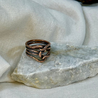 Copper wire ring  on a stone surface with a linen background