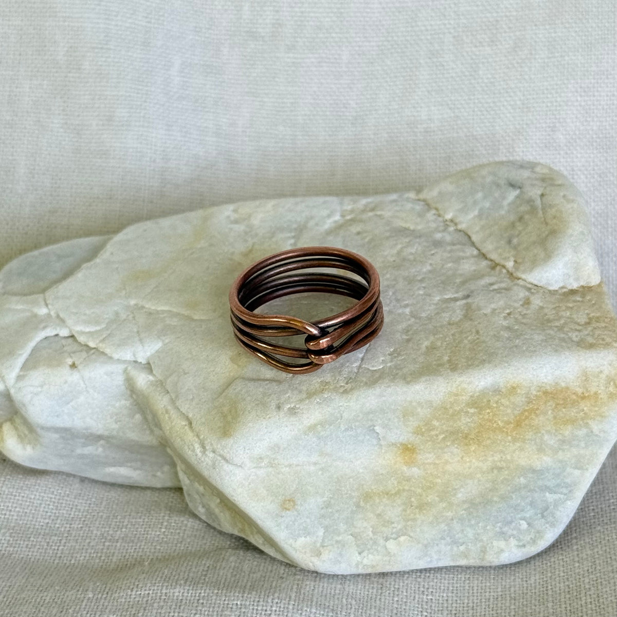 Copper ring on a piece of white stone
