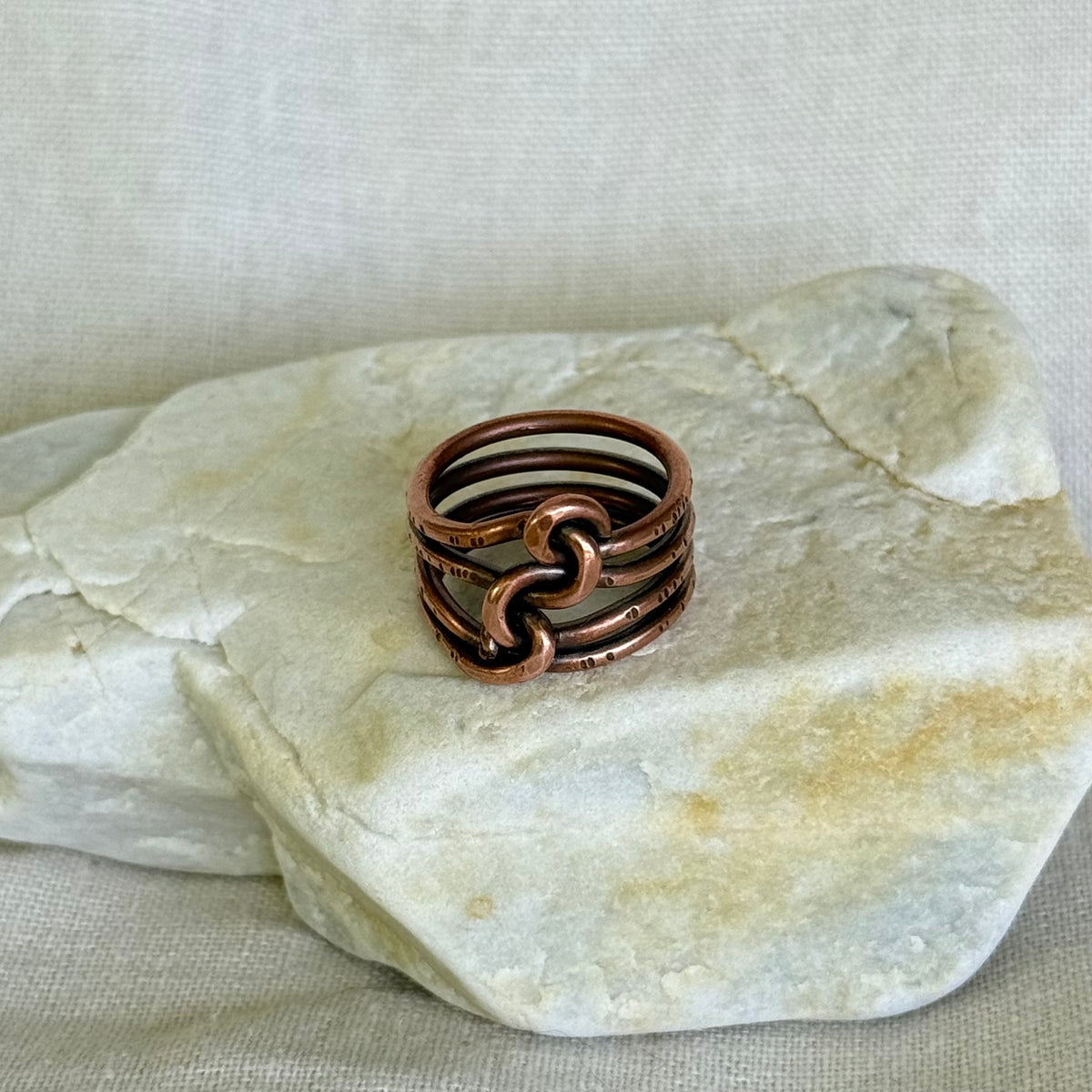 Copper wire ring on a piece of white stone